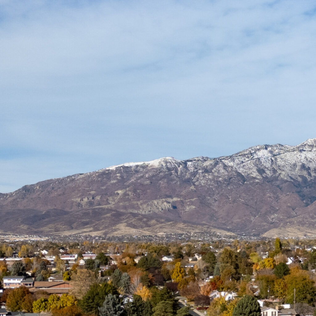 Aerial view of American Fork Utah neighborhood with autumn trees and mountains in the background for Water Damage Restoration American Fork