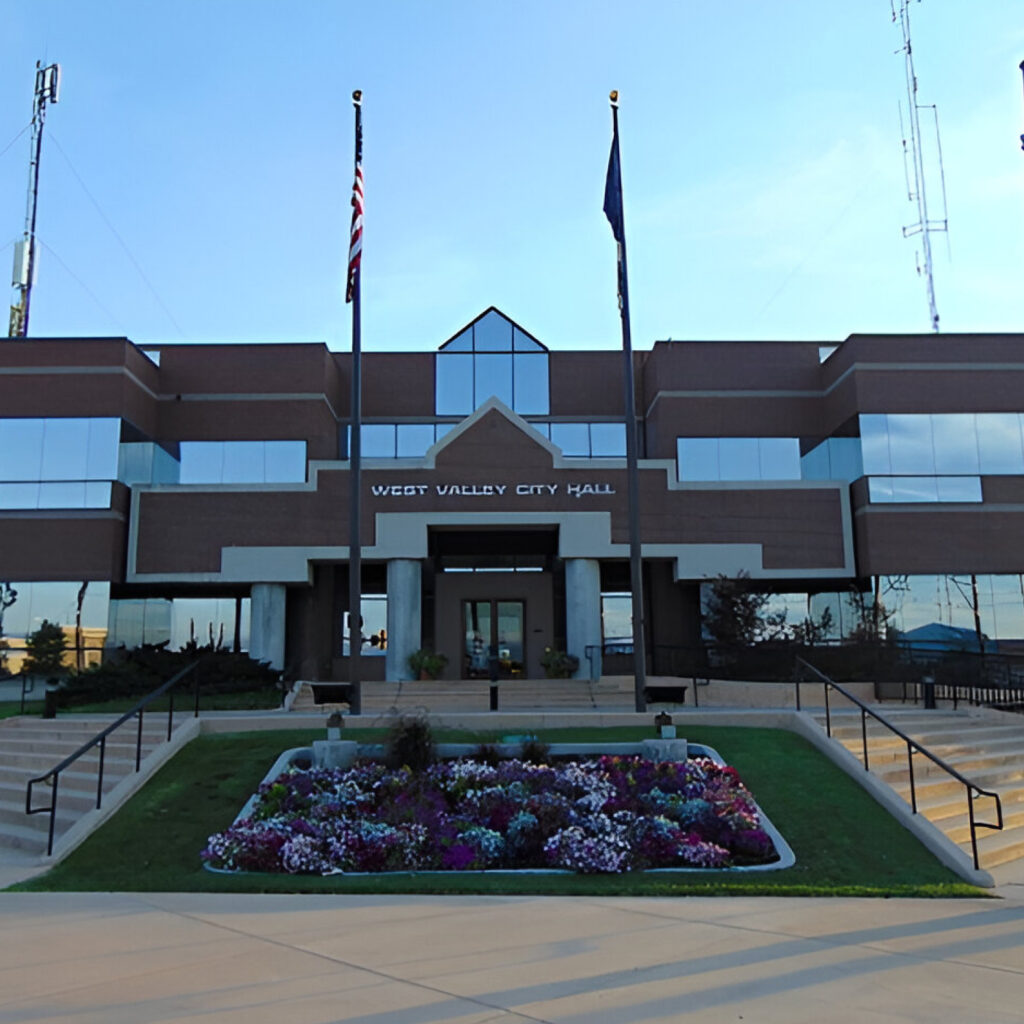 West Valley City Utah City Hall building with flags and flower garden for Water Damage Restoration West Valley City