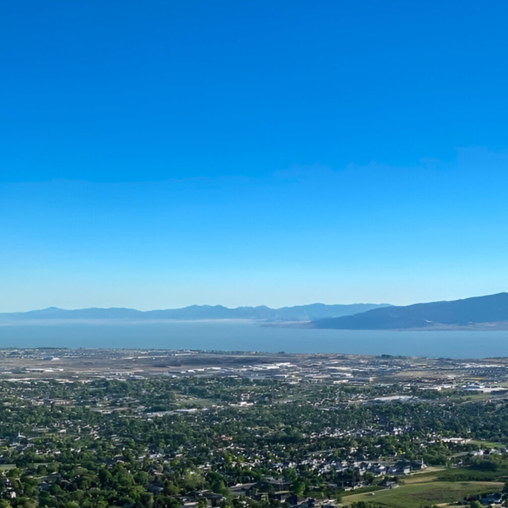 Aerial view of Pleasant Grove Utah with city, trees, and Utah Lake in the background for Water Damage Restoration Pleasant Grove